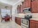Kitchen showcasing stainless steel oven and microwave with dark wood cabinetry at 3148 Bailey Ann Dr, Ormond Beach, FL 32174
