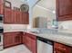 Kitchen featuring stainless steel dishwasher and dark cabinets with modern countertops at 3148 Bailey Ann Dr, Ormond Beach, FL 32174