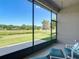 Charming screened lanai with comfortable seating and peaceful views of the serene pond at 3148 Bailey Ann Dr, Ormond Beach, FL 32174