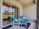 Inviting screened lanai features comfortable furniture, ceiling fan, and access to the outdoors at 3148 Bailey Ann Dr, Ormond Beach, FL 32174