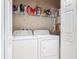 Neat laundry room with white washer and dryer, wire shelving, and storage space at 3148 Bailey Ann Dr, Ormond Beach, FL 32174