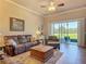 Comfortable living room with ceiling fan and sliding glass doors to the patio at 3148 Bailey Ann Dr, Ormond Beach, FL 32174