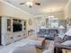 Living room with ceiling fan and large TV entertainment center at 3148 Bailey Ann Dr, Ormond Beach, FL 32174