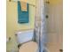 Bright bathroom features a toilet, shower with curtain, and a clean, inviting design at 3170 Ocean Shore Blvd # 5010, Ormond Beach, FL 32176