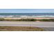 Beautiful beach view featuring blue ocean water, a sandy beach, and a road at 3170 Ocean Shore Blvd # 5010, Ormond Beach, FL 32176