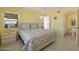 Bright bedroom features comfortable queen bed, window view, and a clean, inviting en suite bathroom at 3170 Ocean Shore Blvd # 5010, Ormond Beach, FL 32176