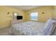 Bedroom with a beach view and TV on dresser at 3170 Ocean Shore Blvd # 5010, Ormond Beach, FL 32176
