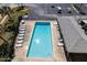 Aerial view of a community pool with several lounge chairs at 3170 Ocean Shore Blvd # 5010, Ormond Beach, FL 32176