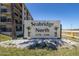 Sign for Seabridge North Condominiums, with tropical palm trees, surrounded by white rocks and grass at 3170 Ocean Shore Blvd # 5010, Ormond Beach, FL 32176