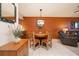 Comfortable dining area with a round wooden table, seating for four, and stylish lighting at 325 Wilder Blvd # A102, Daytona Beach, FL 32114