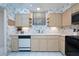 Traditional kitchen featuring light wood cabinets, appliances, and neutral countertops and flooring at 325 Wilder Blvd # A102, Daytona Beach, FL 32114