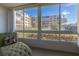 Bright sunroom with large windows overlooking the building complex and lawn at 325 Wilder Blvd # A102, Daytona Beach, FL 32114