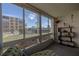 Light sunroom with floor-to-ceiling windows showing a view of the pool and building complex at 325 Wilder Blvd # A102, Daytona Beach, FL 32114