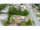 Image of property showing surrounding area, nearby businesses, and heavy tree cover at 32811 County Road 473, Leesburg, FL 34788