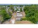 Property featuring several detached buildings, surrounded by lush trees and vegetation at 32811 County Road 473, Leesburg, FL 34788