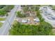 Property showing proximity to nearby buildings, busy street, and parking/storage lot at 32811 County Road 473, Leesburg, FL 34788