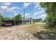 Backyard with a carport and a view of the rear of the house at 32811 County Road 473, Leesburg, FL 34788