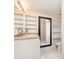 Bathroom featuring built-in shelving, a large mirror, and tiled flooring at 32811 County Road 473, Leesburg, FL 34788