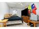 Bedroom with a large screen television, white ceiling fan, and a window at 32811 County Road 473, Leesburg, FL 34788