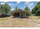 Open carport featuring a grilling area, storage, and parking space at 32811 County Road 473, Leesburg, FL 34788