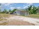 Charming single-story home featuring a gravel driveway and well-lit, welcoming entrance at 32811 County Road 473, Leesburg, FL 34788