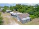 Single-story home with a mixture of metal and shingled roofing, plus additional structures at 32811 County Road 473, Leesburg, FL 34788