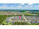 Aerial view of a residential area with a lake, and surrounding greenery, creating a peaceful setting at 3402 Torre Blvd, New Smyrna Beach, FL 32168