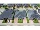 Aerial view of homesites featuring well manicured lawns, paver driveways and mature landscaping at 3402 Torre Blvd, New Smyrna Beach, FL 32168