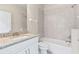 Bright bathroom featuring a granite countertop, a tiled shower/tub, and a white single-sink vanity at 3402 Torre Blvd, New Smyrna Beach, FL 32168