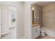 Bathroom featuring a shower-tub combo with grey tiled wall surround and a granite topped vanity at 3402 Torre Blvd, New Smyrna Beach, FL 32168