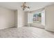 This bedroom features a modern ceiling fan, an exterior window with shutters, and beautiful wood-look flooring at 3402 Torre Blvd, New Smyrna Beach, FL 32168
