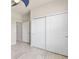 This bedroom features wood-look flooring and access to the hallway and a sliding-door closet at 3402 Torre Blvd, New Smyrna Beach, FL 32168