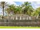 Community entrance featuring a decorative fountain with water feature surrounded by Palm Trees at 3402 Torre Blvd, New Smyrna Beach, FL 32168