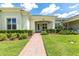 Beautiful home exterior featuring lush landscaping and a brick walkway to the entrance at 3402 Torre Blvd, New Smyrna Beach, FL 32168