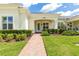 Charming home exterior with manicured landscaping and a brick walkway leading to the front door at 3402 Torre Blvd, New Smyrna Beach, FL 32168