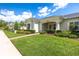 Well-maintained home with green lawn, brick walkway, and neatly trimmed hedges enhancing curb appeal at 3402 Torre Blvd, New Smyrna Beach, FL 32168