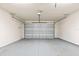 Empty garage interior featuring a functional garage door and painted concrete flooring at 3402 Torre Blvd, New Smyrna Beach, FL 32168