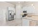 Modern kitchen with stainless steel appliances, granite counters, and plenty of cabinet space at 3402 Torre Blvd, New Smyrna Beach, FL 32168