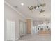 Bright living room with wood flooring, ceiling fan, and open floor plan leading into the kitchen at 3402 Torre Blvd, New Smyrna Beach, FL 32168