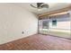 Enclosed patio with a brick floor, ceiling fan, and screened windows, perfect for outdoor relaxation at 3402 Torre Blvd, New Smyrna Beach, FL 32168