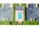 Overhead shot of a community pool surrounded by well-maintained lawns and palm trees at 3402 Torre Blvd, New Smyrna Beach, FL 32168