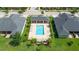 Aerial view of a community pool with lounge chairs, umbrellas, and palm trees at 3402 Torre Blvd, New Smyrna Beach, FL 32168