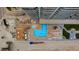 An aerial view of a pool and lounge area with chairs and tables overlooking a sandy beach at 3425 S Atlantic Ave # 1602, Daytona Beach, FL 32118
