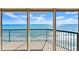 Ocean view from the balcony looking through the sliding glass doors with black railing in the foreground at 3425 S Atlantic Ave # 1602, Daytona Beach, FL 32118