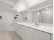 Bright, neutral bathroom featuring double sinks, a soaking tub and large mirror at 3425 S Atlantic Ave # 1602, Daytona Beach, FL 32118
