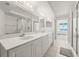 Neutral bathroom featuring double sinks, a walk-in shower and large mirror at 3425 S Atlantic Ave # 1602, Daytona Beach, FL 32118