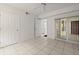 Neutral bedroom with white walls, tile flooring, ceiling fan, and access to other rooms at 3425 S Atlantic Ave # 1602, Daytona Beach, FL 32118
