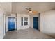 Entryway featuring tiled floor, textured walls, a window, 2 blue painted doors, and a ceiling fan at 3425 S Atlantic Ave # 1602, Daytona Beach, FL 32118