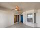 Entryway featuring tiled floor, textured walls, a window, a blue painted door and a ceiling fan at 3425 S Atlantic Ave # 1602, Daytona Beach, FL 32118