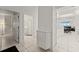 Hallway view with white cabinets and tile floors that leads to the bathroom and the living area at 3425 S Atlantic Ave # 1602, Daytona Beach, FL 32118